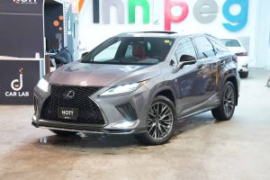 A dark metallic grey hybrid luxury Lexus RX 450h displayed in the Nott Autocorp Winnipeg showroom.